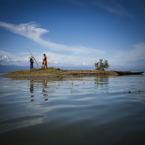 two people are standing in an island that watered around 