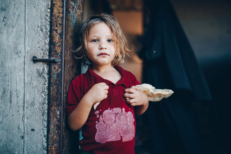 Taken before the crisis began on October 7, Suha holds a peice of bread in Gaza. 