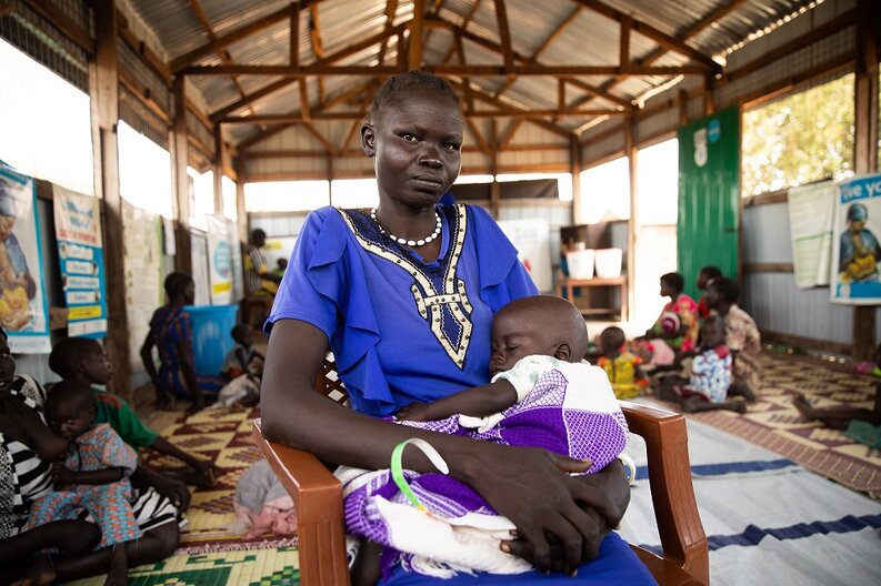Adut (28) and Baby Achan (1½) wait to be seen at the WFP supported Alek Nutrition Center in Warrap State.  © WFP/Samantha Reinders