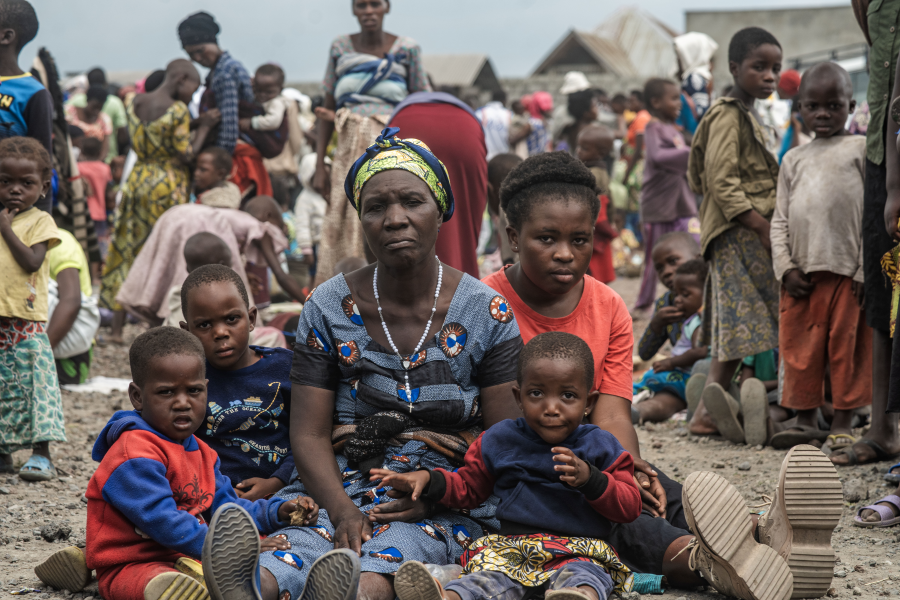 Photo by WFP/Michael Castofas. A mother with her children displaced by violence wait to register with SCOPE to receive the first assistance. She has lived in the Rusayo camp, close to Goma since November 2023. 