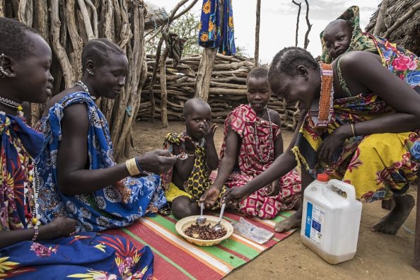 Photo: WFP/ Gabriela Vivacqua, A family enjoys a meal together in Kapoeta, South Sudan. Without assistance most families were resorting to skipping meals or reducing meal portions to tide the tough times.