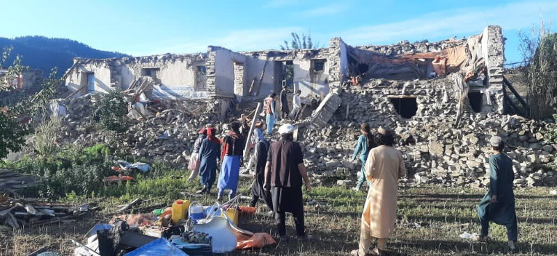 Photo: WFP/Sheer Ali. People in Soor Kawkh village in Spera, Afghanistan, assess damage to buildings. 