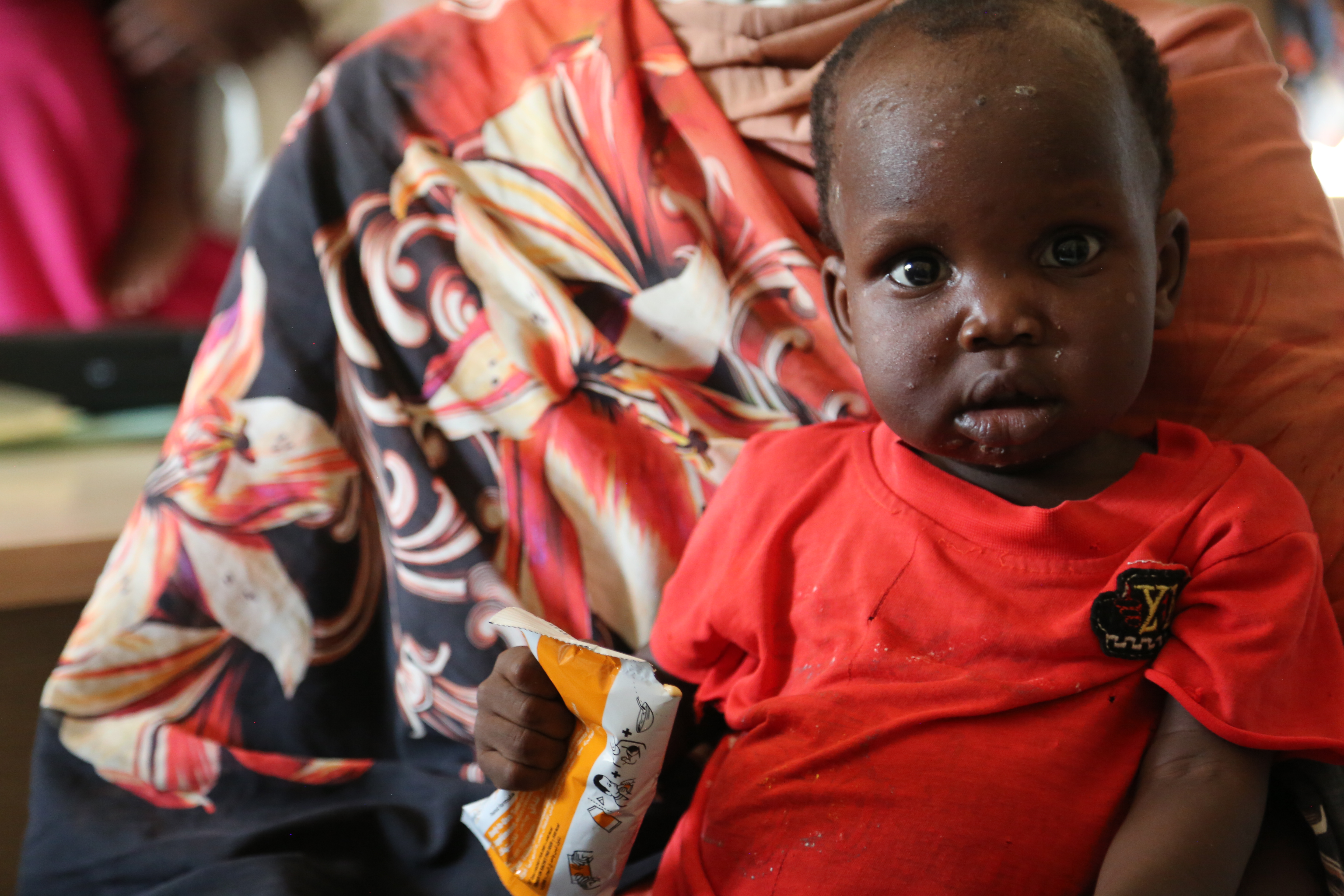 Akol and her son were South Sudanese refugees in Khartoum. When the conflict hit they fled to Port Sudan, where Akol's son is now receiving treatment for malnutrition at a WFP-supported health center. WFP is providing emergency food and nutrition assistance to newly displaced families, but delivering aid to conflict hotspots like Khartoum is extremely challenging. ©WFP/Leni Kinzli 