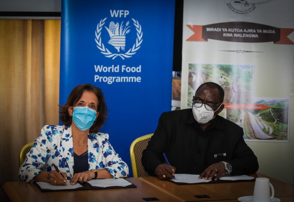WFP/Ove Dissing-Spandet, WFP Country Director and Representative in Tanzania, Sarah Gordon-Gibson and Executive Director, TASAF, Mr. Ladislaus Mwamanga signing the MoU