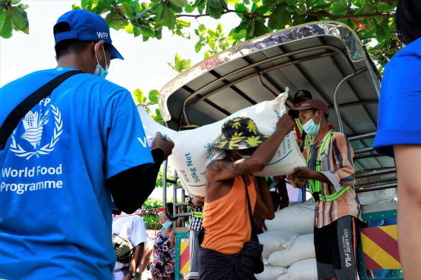 WFP/Photo library, On 13 May, families in impoverished Hlaing Tharyar township, Yangon, receiving food rations from WFP. In response to rising hunger, WFP has just launched a new emergency operation, targeting 2 million people in urban areas