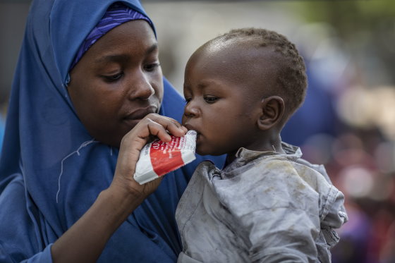 Photo: WFP/Siegfried-Modola, Aisha, 25, feeds her baby boy Sadiki, 1 with Plumpy'Nut, a peanut-based paste for treatment of severe acute malnutrition, in an IDP camp in Bama, Borno state. 