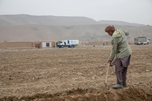 Photo: WFP/Julian Frank, People Farming in Balkh Province with WFP Convoy in Background