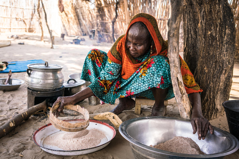 Photo: WFP/ Evelyn Fey Yakoua. Chad. An older woman is preparing a meal in her rural kitchen