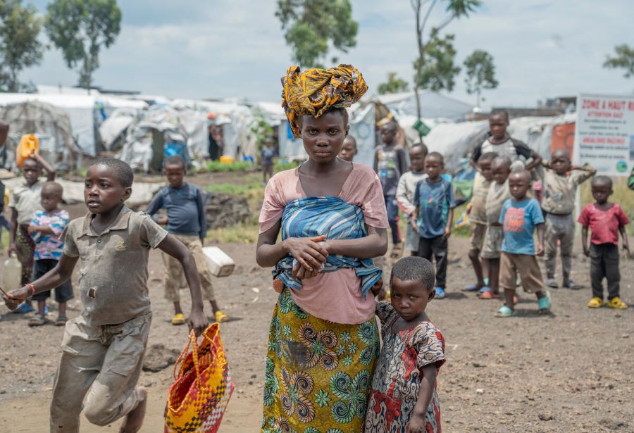 WFP/Benjamin Anguandia. Asifiwe is a 24-year-old mother who has been displaced for the past five months. She had to embark on a long and arduous journey to reach the camp on Goma's outskirts. Life in the camp has been very challenging for her, especially when meeting basic needs such as food and shelter.