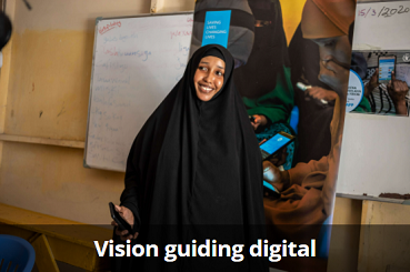 Hani Mohamed (24) uses her mobile phone to order food from an online E-shop at a WFP food distribution Centre at K4 area in Mogadishu. Photo: WFP/Ismail Taxta