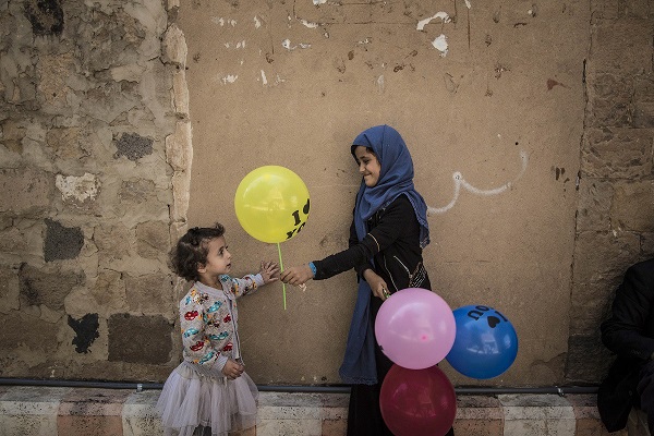 A girl sells balloons
