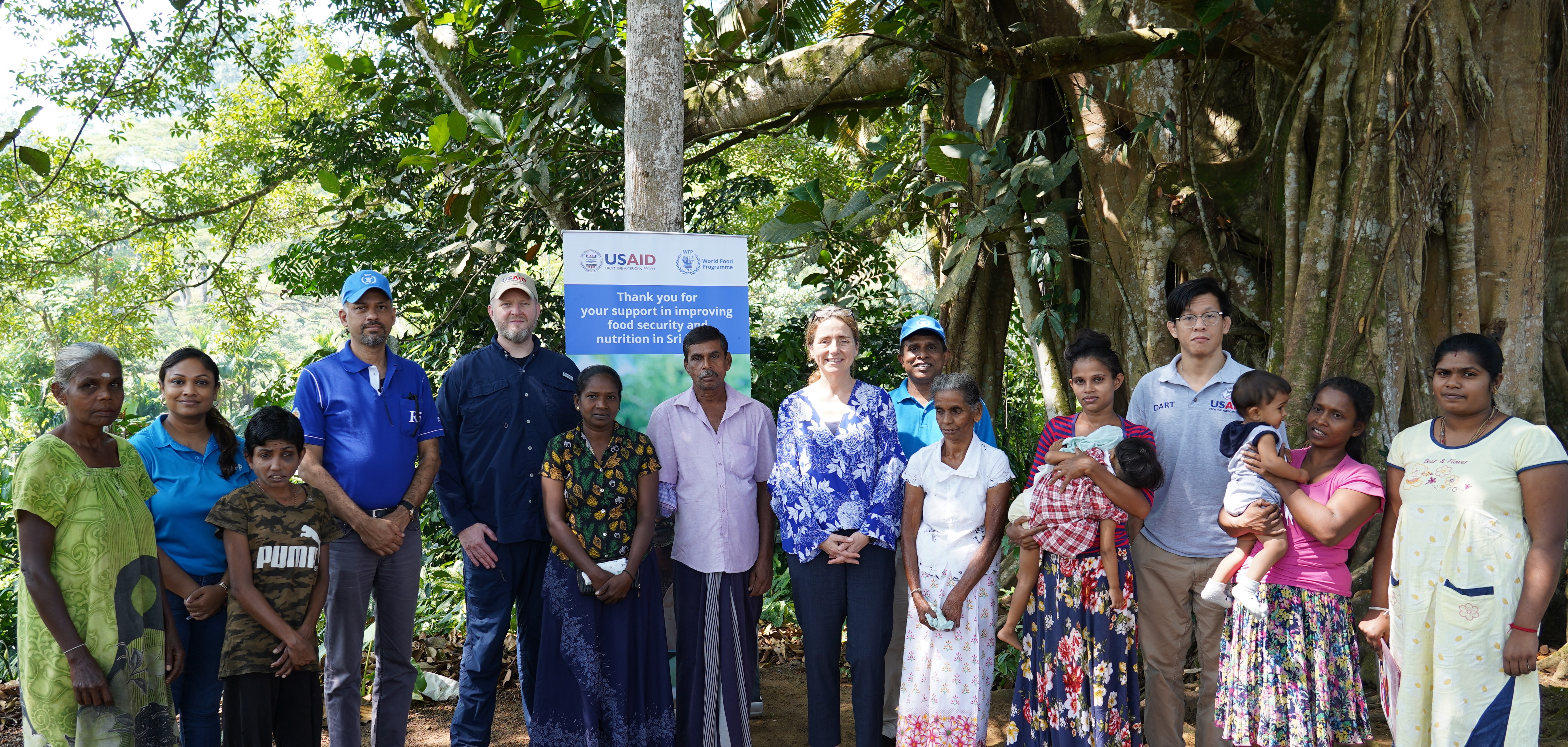 Stephanie Wilcock, Director for Asia, Latin America, and the Caribbean of USAID’s Bureau for Humanitarian Assistance with a group of people in Rathnapura enrolled to receive WFP cash assistance through USAID funding. 