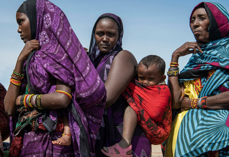 Women queue to receive food items (sorghum, pulses, oil) at a WFP general food distribution point in the village of Malabot in Marsabit County in northern Kenya 