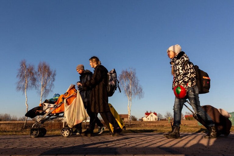 A family from Ukraine affected by the war, walking to the Poland border