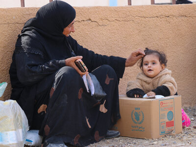 A displaced Syrian family returning from Lebanon to Syria, Deir ez-Zor, following the eruption of the conflict in Lebanon, receives WFP food assistance to help meet their immediate food needs upon arrival in Syria.