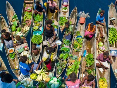 Aerial photo of long boats full of fruit and vegetables