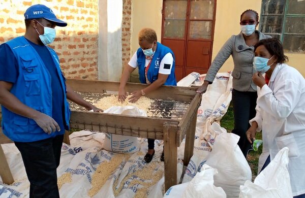 Caroline (C) checks the quality of maize before purchase. Damaged kernels and impurities such as stones must be removed (R). Photos: WFP