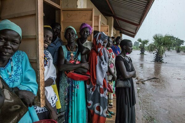South Sudanese women taking shelter from flooding
