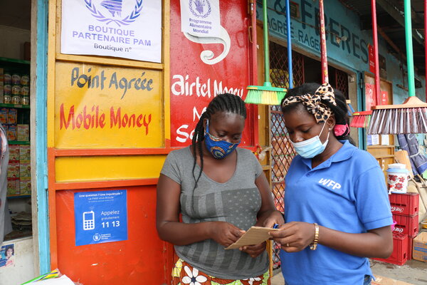 Two women standing and looking at a card