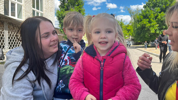 Child singing in front of a basement shelter in Kharkiv