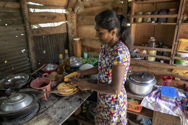 A mother cooks in a kitchen