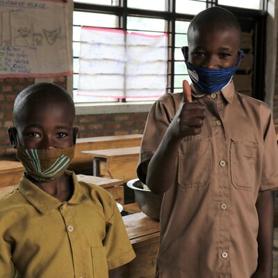 Francine's children Lambert and Donat are taught about the importance of a healthy diet. Photos: WFP/Emily Frendenberg
