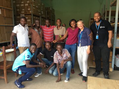 Staff standing and crouching facing camera