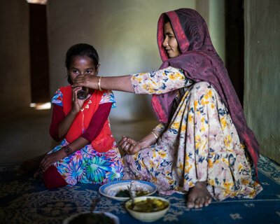 Hason Ara feeds her daughter