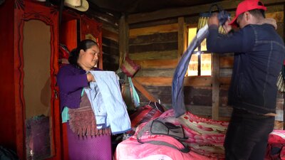 a man and a woman are folding clothes