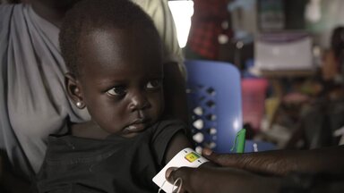 A kid being measured by WFP team
