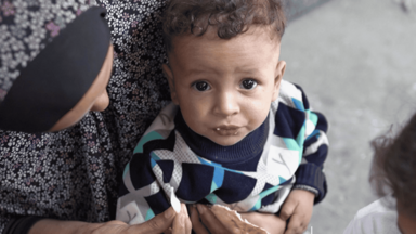 Palestine. Mother holding baby in her arms