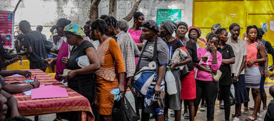 A line of women wait to register at a food distribution in Port-au-Prince