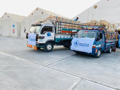 Trucks packed with 3 metric tons of high-energy biscuits ready to set off in Kunar province on Tuesday (2 September)