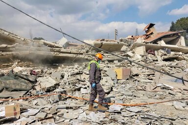 A Lebanese civil defence inspects destruction at the site of an airstrike that targeted the village of Houch el-Rafqa, in the Bekaa valley on 2 March 2026. 