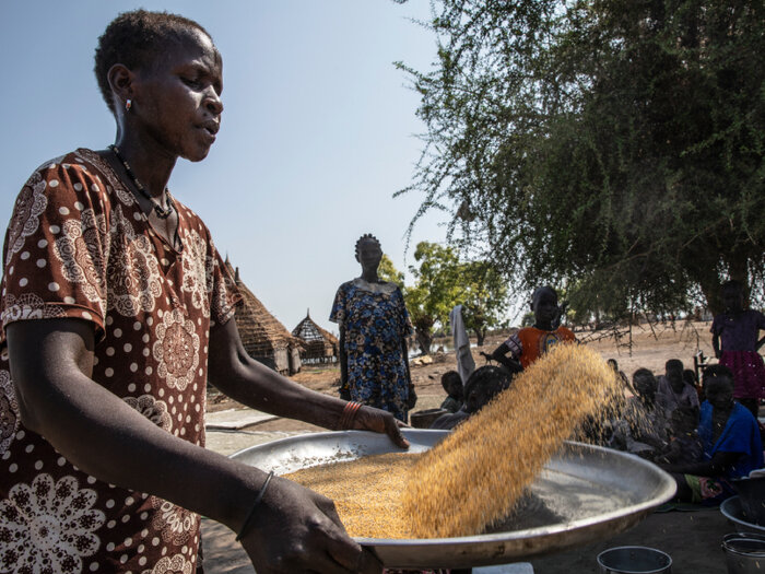 a woman is preparing maize