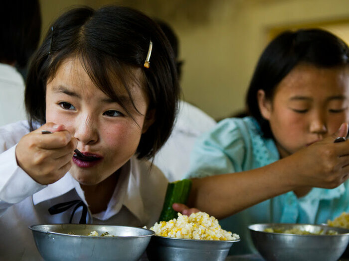 School girls eating nutritious meals provided by WFP to alleviate child malnutrition in DPR Korea