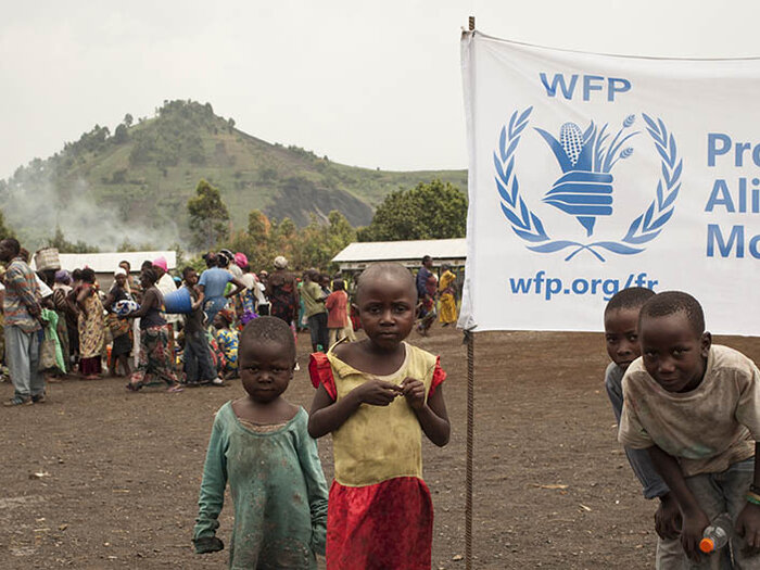 Men, women and children in WFP's distribution center in DR Congo