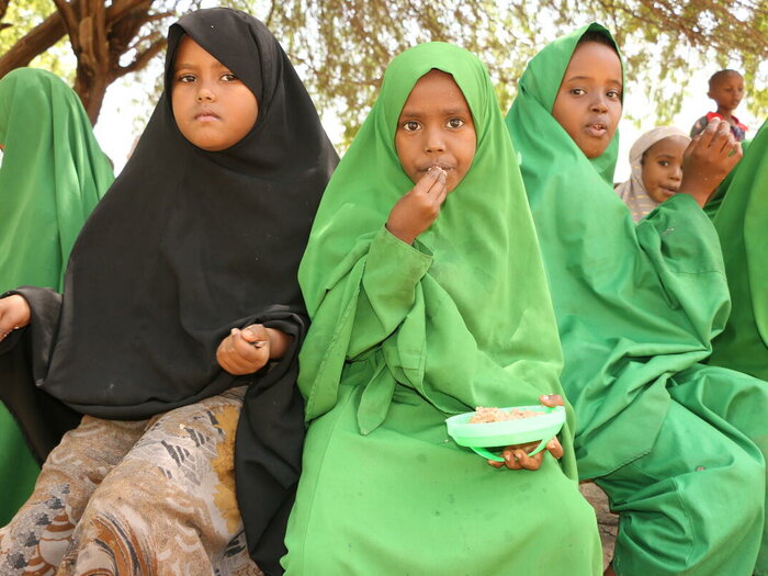 School children at Jaribu Primary School, Garissa, enjoy a hot lunch.