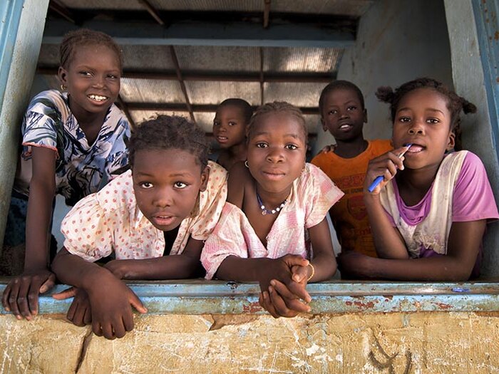 Group of children on the window sill of their classroom