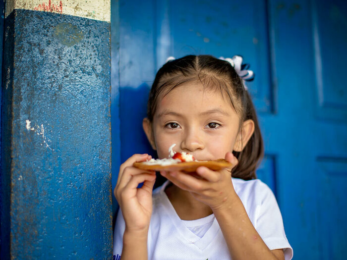 Child eating healthy and nutritious school meals provided by WFP