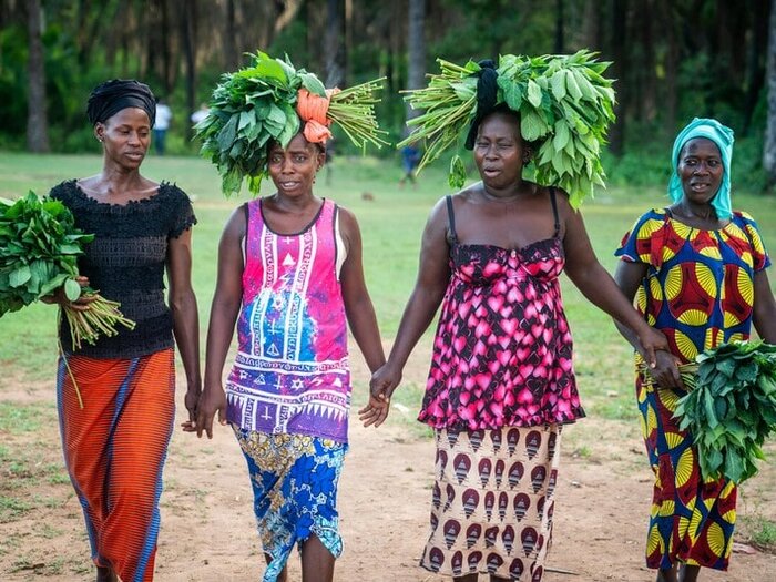 Female farmers walking and holding hands