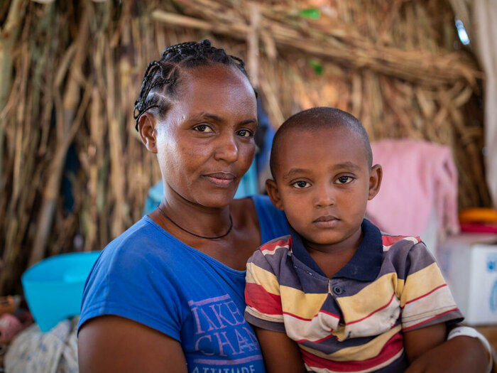 28-year-old Zanabi with her son Filimon (age 4) in an informal shelter in Um Rakuba refugee camp in Sudan.