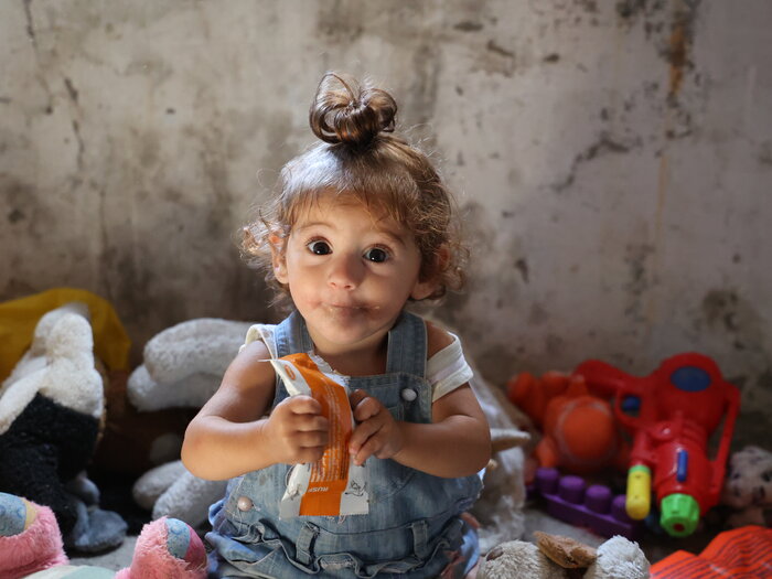 a child is holding a WFP snack