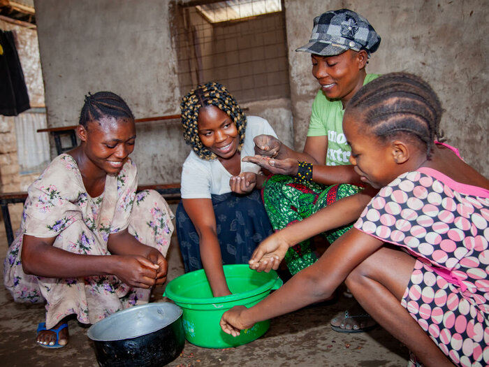 Louise Ibrahim and her three daughters sort beans in the preparation of a family meal in their home in Kakuma. WFP buys food from smallholder farmers to distribute to refugees in Dadaab and Kakuma.