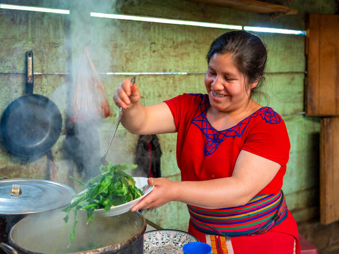 Maria prepares a meal at her home in the Pexlá Grande community of Nebaj municipality, Quiché, Guatemala, on 3 August 2023.