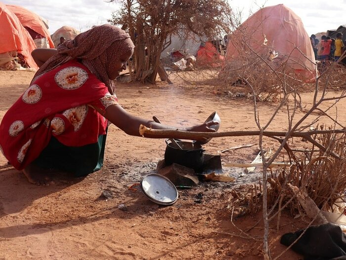 A woman cooks breakfast in Ladan camp for internally displaced persons, Dolow, Somalia.