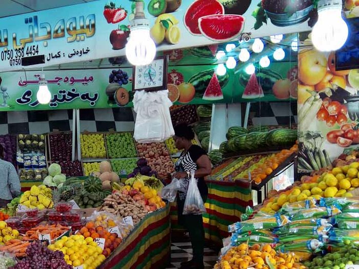 Woman buying fresh fruits and vegetables