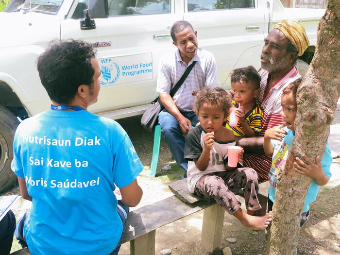 WFP staff discuss nutrition with a father of three.  