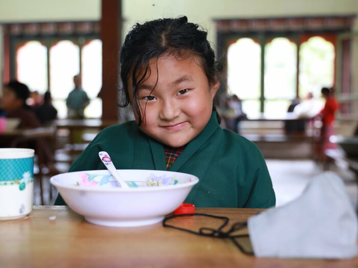 Girl at school having her school meal distributed by WFP in Bhutan