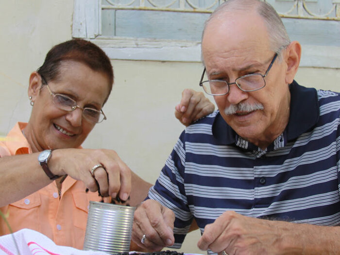 Elderly man and woman sorting beans